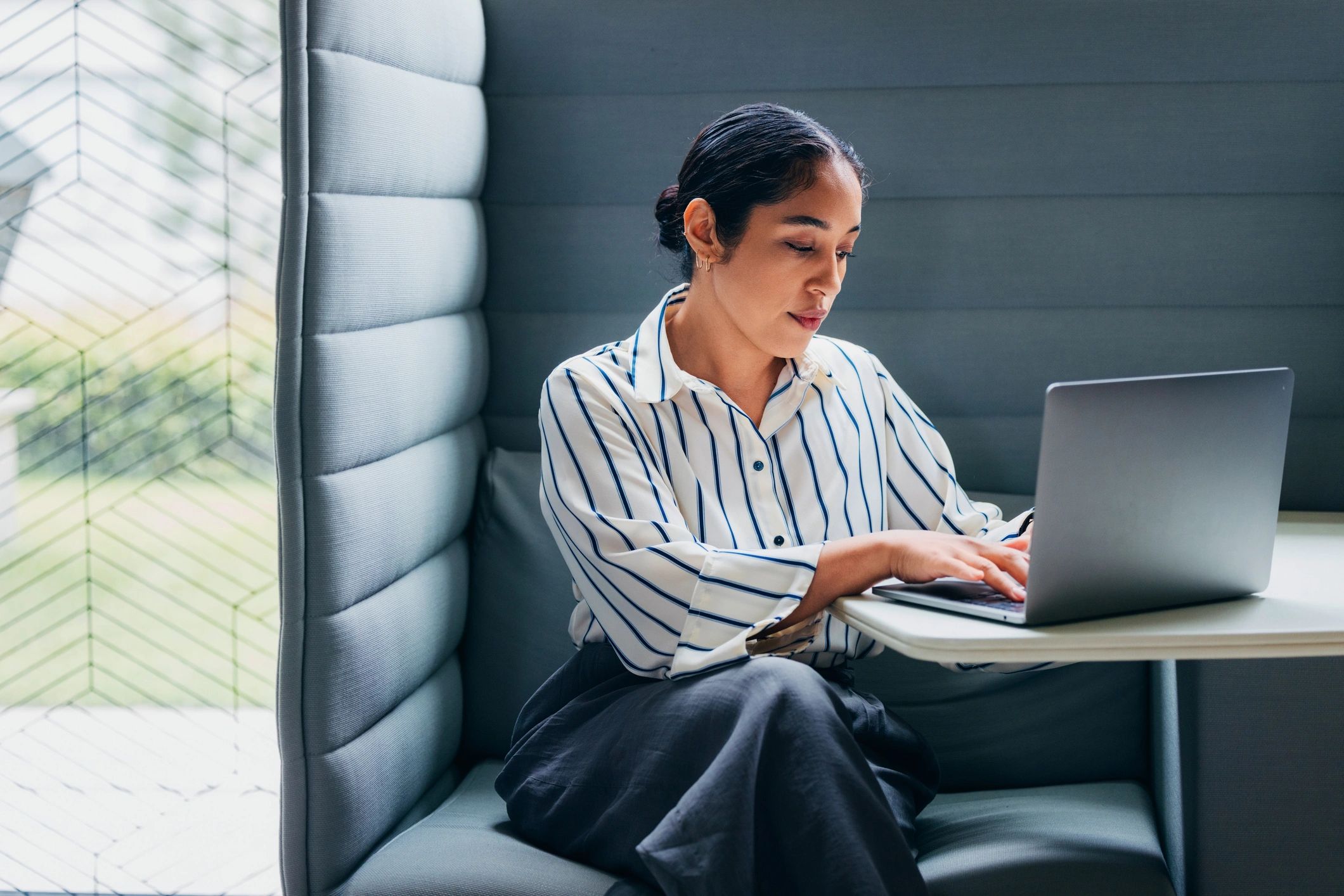 Business professional working on laptop for real estate support