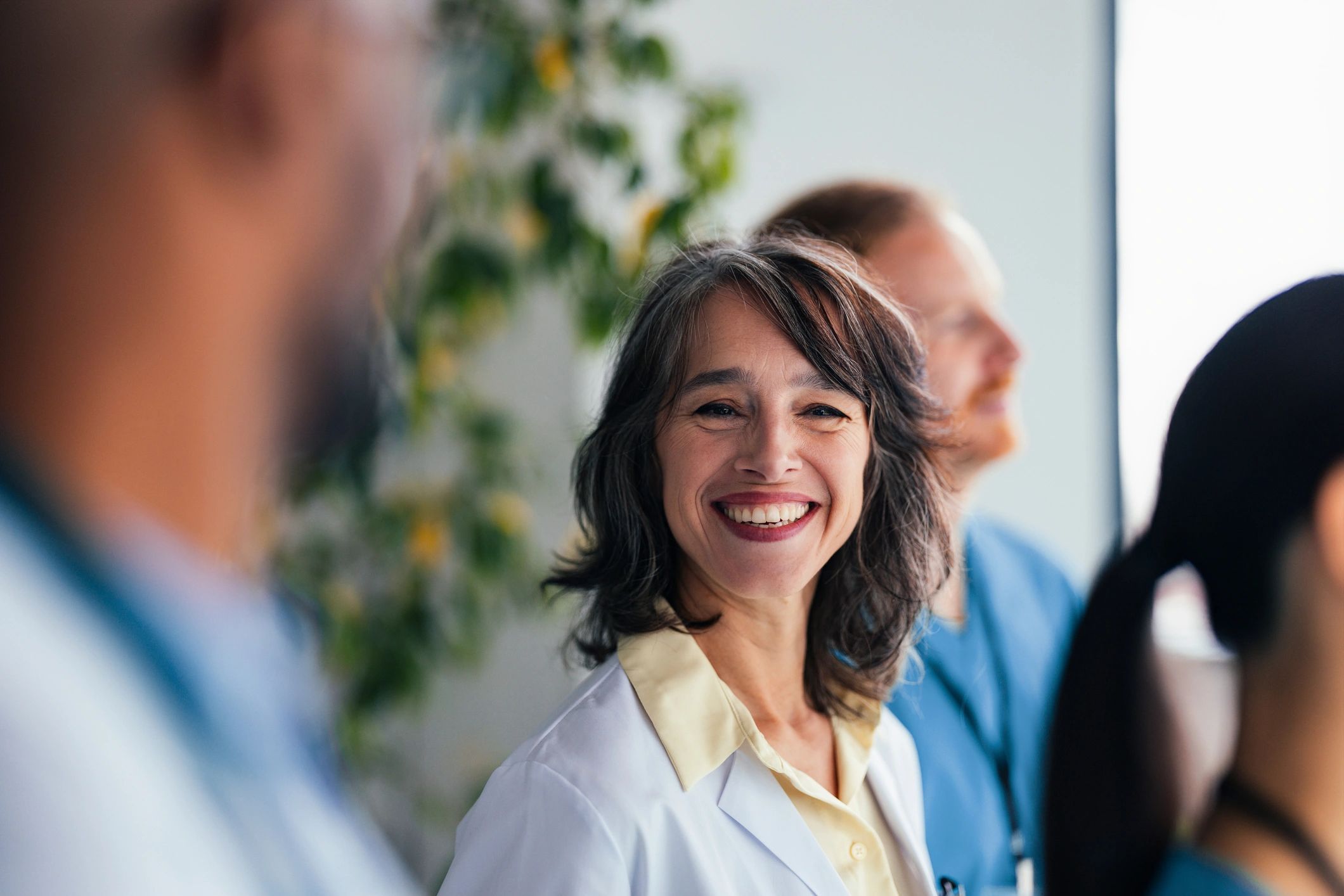 Healthcare team in office corridor representing administrative support